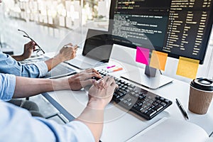 Writing codes and typing data code technology, Programmer cooperating working on web site project in a software developing on