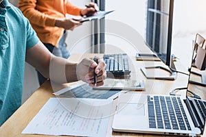 Writing codes and typing data code technology, Programmer cooperating working on web site project in a software developing on