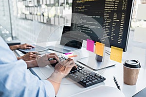 Writing codes and typing data code technology, Programmer cooperating working on web site project in a software developing on