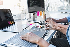 Writing codes and typing data code technology, Programmer cooperating working on web site project in a software developing on