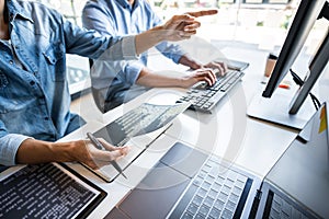 Writing codes and typing data code technology, Programmer cooperating working on web site project in a software developing on