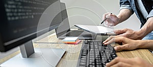 Writing codes and typing data code technology, Programmer team working on web site project in a software development on desktop
