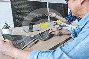 Writing codes and typing data code technology, Two professional programmer cooperating working on web site project in a software