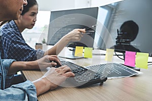 Writing codes and typing data code technology, Two professional programmer cooperating working on web site project in a software