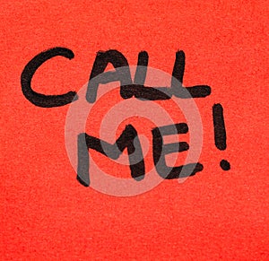 Writing on colorful sticky note Call me. Text with Call me on paper. Sticky note, post it on keyboard