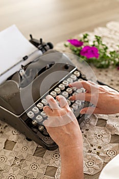 Writing concept. Hands typing on retro typewriter.