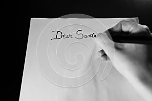 Writing Dear Santa for Christmas. Christmas letter. Text Dear Santa on paper