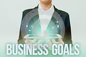 Writing displaying text Business Goals. Business overview Expectation to accomplish over a specific period of time Lady