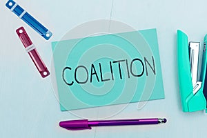 Writing displaying text Coalition. Word for a temporary alliance of distinct parties, persons, or states for joint