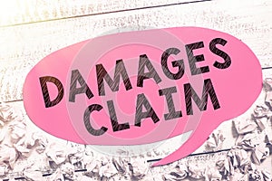 Handwriting text Damages Claim. Word Written on Demand Compensation Litigate Insurance File Suit photo