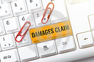 Writing displaying text Damages Claim. Concept meaning Demand Compensation Litigate Insurance File Suit Typing Online