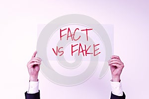 Writing displaying text Fact Vs Fake. Business approach Rivalry or products or information originaly made or imitation photo