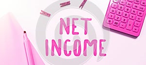 Writing displaying text Net Income. Business idea the gross income remaining after all deductions and exemptions are