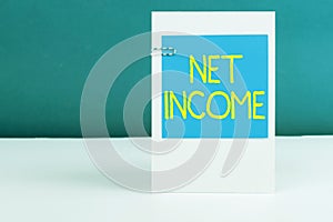Writing displaying text Net Income. Concept meaning the gross income remaining after all deductions and exemptions are