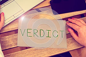 Writing displaying text Verdict. Business overview decision on disputed issue in a civil or criminal case or inquest