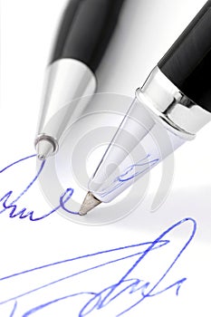 Writing a handwritten signature.