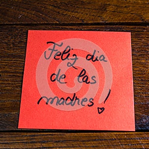 Writing happy mother`s day in Spanish feliz dia de las madres on memo post reminder. Text on sticky paper. Mother`s day concept photo