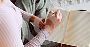 Writing, journal and zen woman hands with notebook for poetry, creative ideas or healing on her living room floor