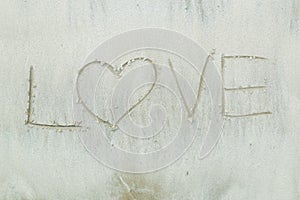 Writing letter love on sand.