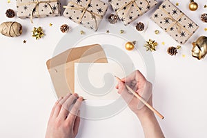 Writing letter to Santa Claus concept. Top above overhead close up first person view photo of female hands holding pen and blank