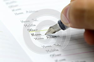 Writing the name on a paper with a pen using for concept of Namesake day