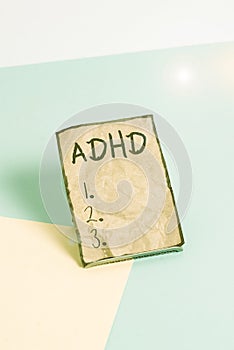 Writing note showing Adhd. Business photo showcasing Mental health disorder of children Hyperactive Trouble paying attention Paper