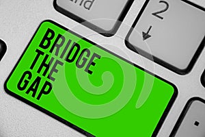 Writing note showing Bridge The Gap. Business photo showcasing Overcome the obstacles Challenge Courage Empowerment Keyboard green