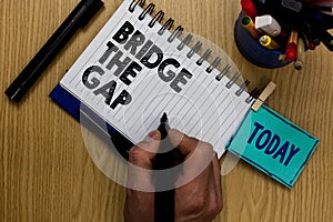 Writing note showing Bridge The Gap. Business photo showcasing Overcome the obstacles Challenge Courage Empowerment Man holding ma