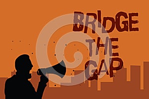 Writing note showing Bridge The Gap. Business photo showcasing Overcome the obstacles Challenge Courage Empowerment Man holding me