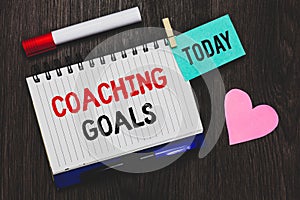 Writing note showing Coaching Goals. Business photo showcasing Empowers individuals Encourages them to take responsibility Open no
