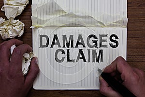 Writing note showing Damages Claim. Business photo showcasing Demand Compensation Litigate Insurance File Suit Man holding marker