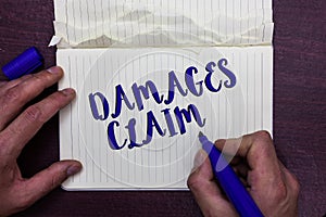 Writing note showing Damages Claim. Business photo showcasing Demand Compensation Litigate Insurance File Suit Man holding marker