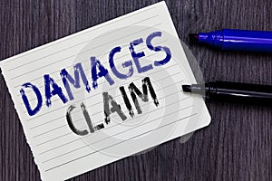 Writing note showing Damages Claim. Business photo showcasing Demand Compensation Litigate Insurance File Suit Notebook Paper Remi photo