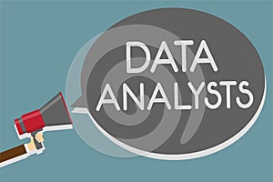 Writing note showing Data Analysts. Business photo showcasing Programmer Design and Create Report Identifies patterns Man holding