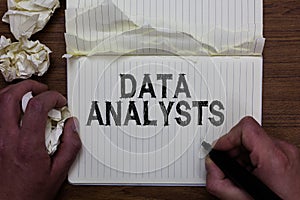Writing note showing Data Analysts. Business photo showcasing Programmer Design and Create Report Identifies patterns Man holding