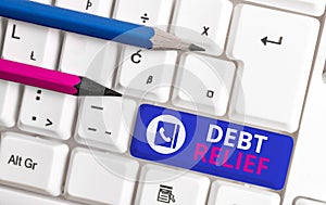 Writing note showing Debt Relief. Business photo showcasing partial or total remission of it especially those by