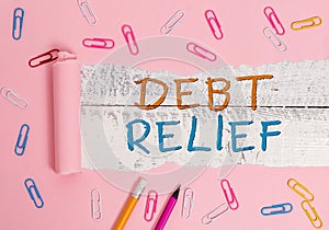 Writing note showing Debt Relief. Business photo showcasing partial or total remission of it especially those by