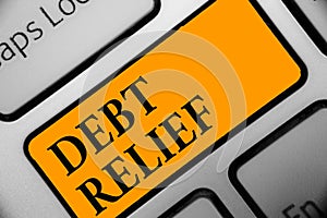 Writing note showing Debt Relief. Business photo showcasing partial or total remission of it especially those by countries Keyboar