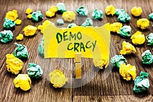 Writing note showing Demo Cracy. Business photo showcasing freedom of the people to express their feelings and beliefs Clothespin