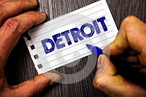 Writing note showing Detroit. Business photo showcasing City in the United States of America Capital of Michigan Motown Man hold