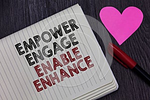 Writing note showing Empower Engage Enable Enhance. Business photo showcasing Empowerment Leadership Motivation Engagement Striket