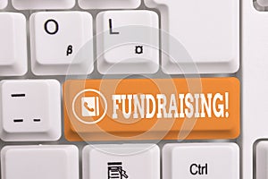 Writing note showing Fundraising. Business photo showcasing seeking to generate financial support for charity or cause