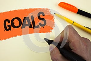 Writing note showing Goals. Business photo showcasing Desired Achievements Targets What you want to accomplish in the future writ