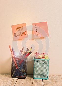 Writing note showing Guest Blogging. Business photo showcasing used by the owners of blogs to increase traffic to their site Two