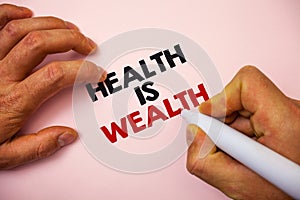 Writing note showing Health Is Wealth. Business photo showcasing being in good shape great value Stay healthy eat Healthy Marker