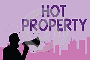 Writing note showing Hot Property. Business photo showcasing Something which is sought after or is Heavily Demanded Man holding me