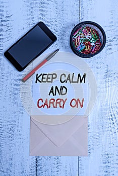 Writing note showing Keep Calm And Carry On. Business photo showcasing slogan calling for persistence face of challenge Smartphone