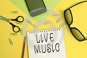 Writing note showing Live Music. Business photo showcasing performance given by one or more singers or instrumentalists Sheet photo