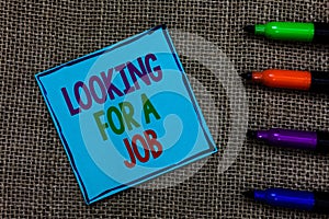 Writing note showing Looking For A Job. Business photo showcasing Unemployed seeking work Recruitment Human Resources Blue paper o