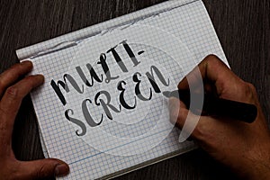 Writing note showing Multi Screen. Business photo showcasing Having or involving several screen especially in a cinema Man hand ho